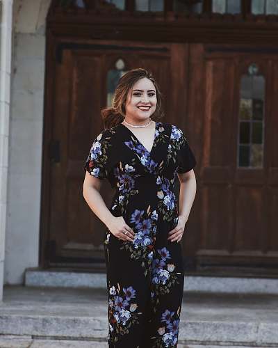 clothing smiling woman with both hands on tummy evening dress