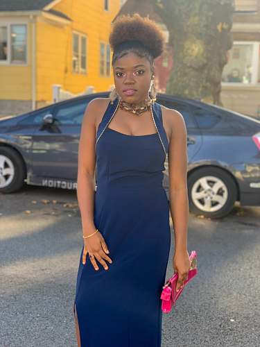 clothing standing woman wearing blue sleeveless dress during daytime evening dress