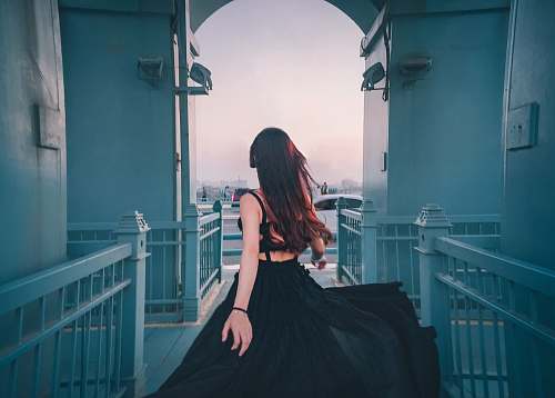 clothing woman in black sheer lace spaghetti strap dress standing indors robe