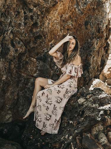 clothing woman in sitting on stone and holding head fashion