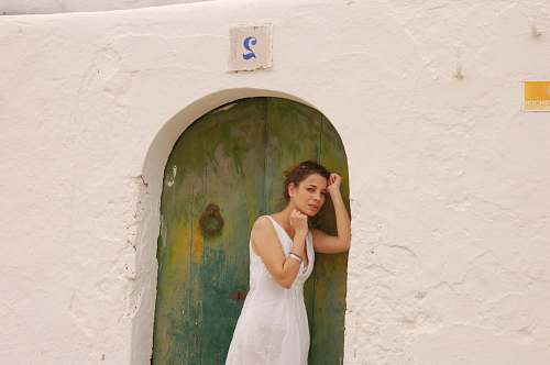 clothing woman in white dress leaning on green and blue door during daytime ] evening dress