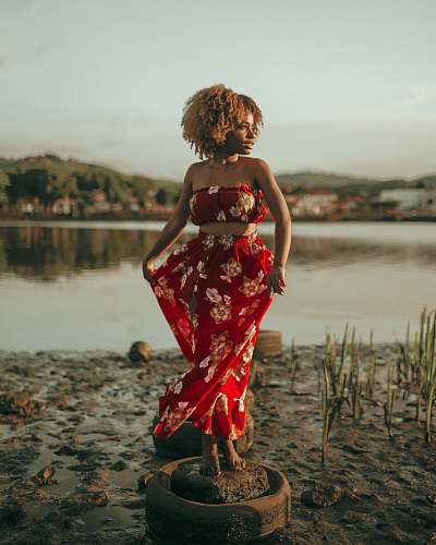 clothing woman standing near body of water evening dress