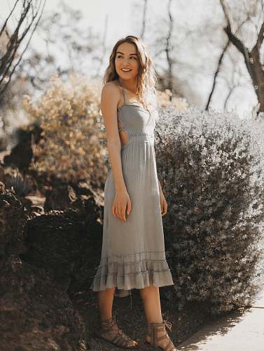 clothing woman wearing gray halter dress near green plant evening dress