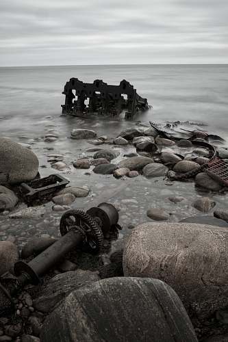grey sea under cloudy sky rubble