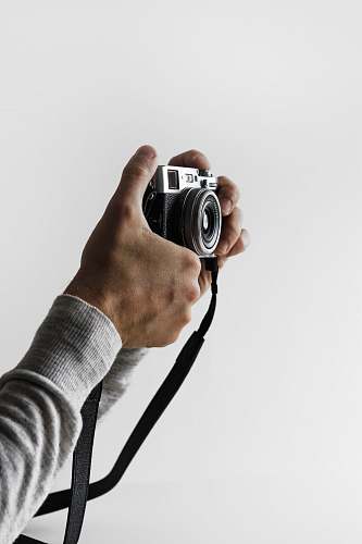 human person holding gray and black camera person