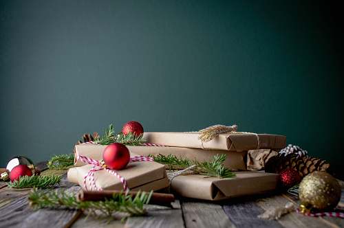 holiday gift boxes with red baubles on top couch