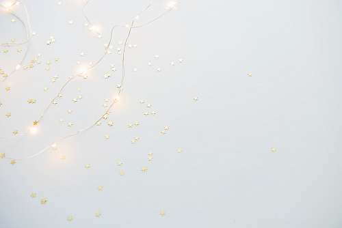 grey star sequins on white platform background