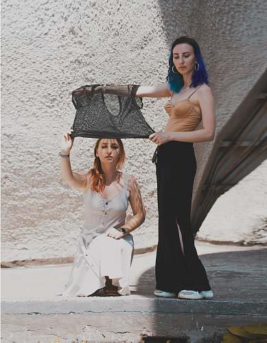 apparel two women near wall evening dress