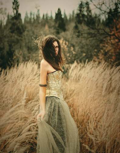 apparel woman in green dress near field evening dress