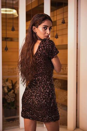 apparel woman standing near glass door evening dress