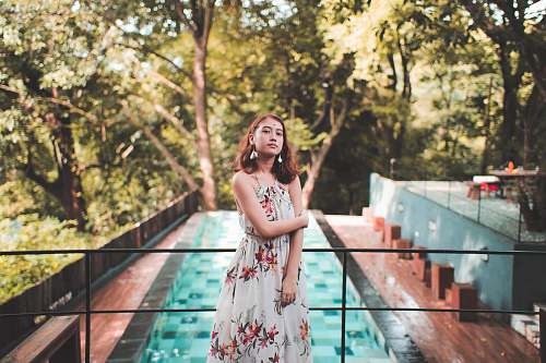 apparel woman standing near railings evening dress