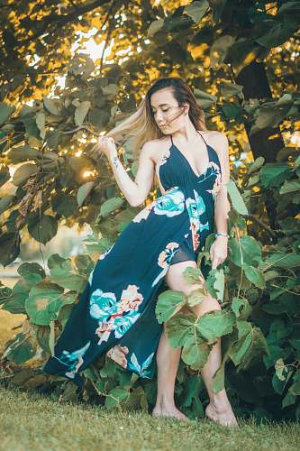 apparel woman standing near tree gown