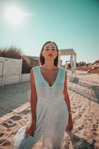 apparel woman wearing white sleeveless dress evening dress