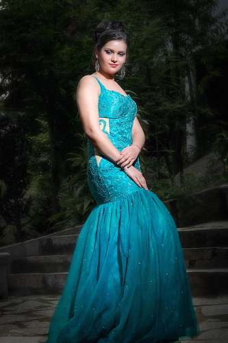 clothing standing woman wearing blue spaghetti strap dress during daytime apparel