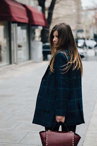 woman woman holding brown leather bag in bokeh photography female