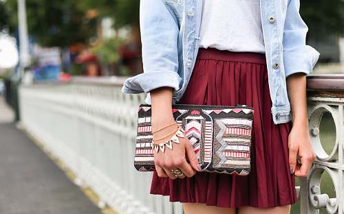 woman woman holding clutch bag standing beside white bridge style