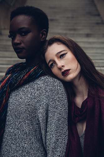 people woman leaning her head to another woman during daytime woman