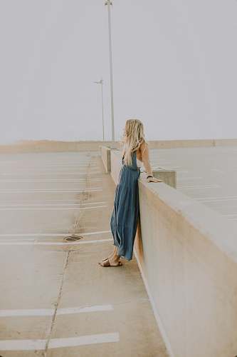 clothing woman leaning on wall apparel