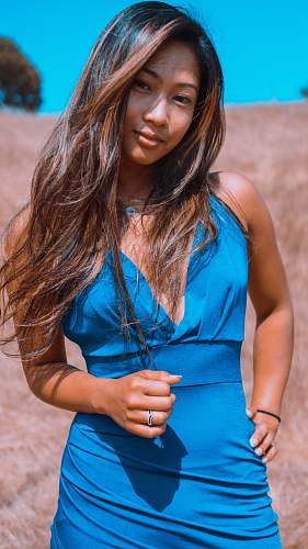 apparel woman standing on brown grass during daytime clothing