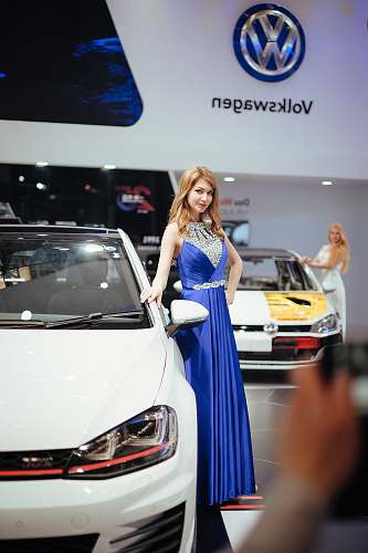 apparel woman stands near Volkswagen car evening dress
