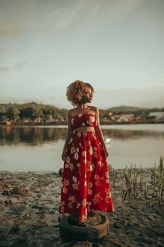 apparel woman wearing red and white floral sleeveless pleated maxi dress clothing