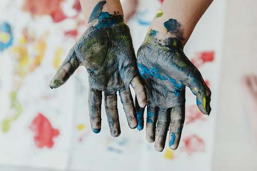 kid person hands with green paint blossom