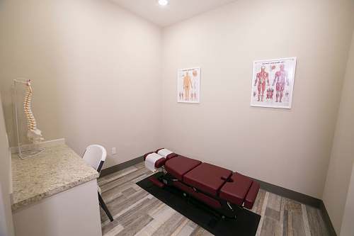 indoors red leather padded massage bed inside building interior design