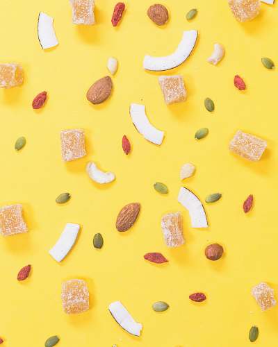 sweets nuts and beans on yellow surface confectionery