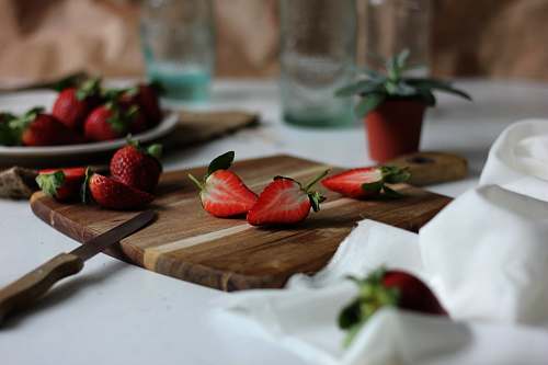 fruit sliced strawberries on chopping board strawberry