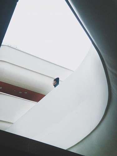 architecture man standing near white concrete railings window