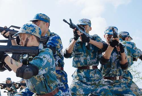 person five men pointing rifles during day military