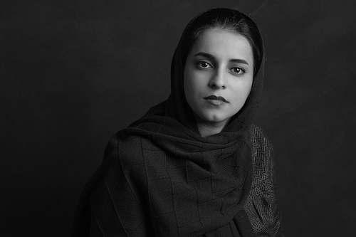 black-and-white grayscale photo of woman in hijab face