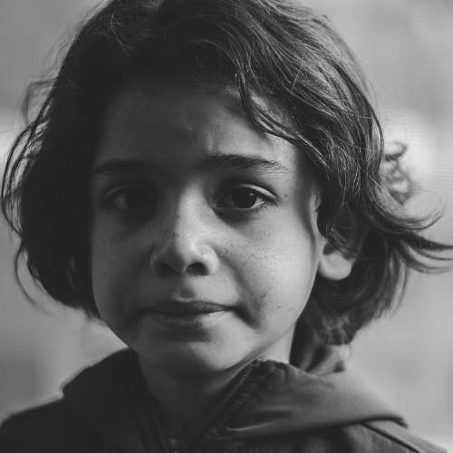 face grayscale photography of boy in zip-up jacket black-and-white