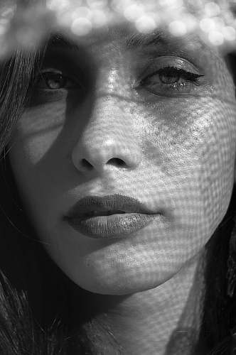 person grayscale photography of woman's face black-and-white