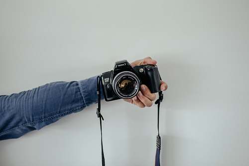 person person holding black camera camera