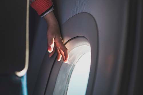 person person touching airplane window hand