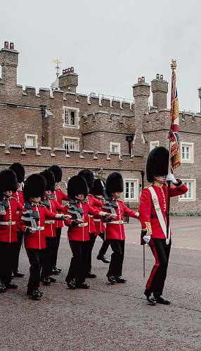 person royal guards parading near building during day military