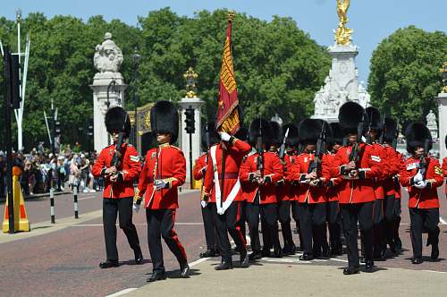person royal guards walking near people military