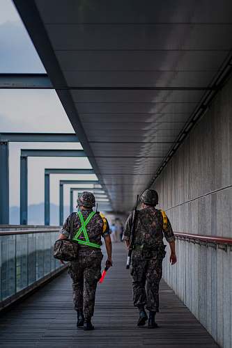 person two soldier men walking on pathway military