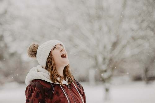 person woman wearing bobble cap looking upwards selective focus photography people