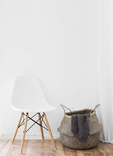 home white and brown chairs beside wicker basket near white wall furniture