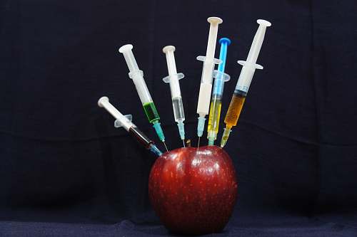 health apple fruit with plastic syringes red
