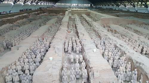 grey terracotta soldiers inside warehouse military uniform