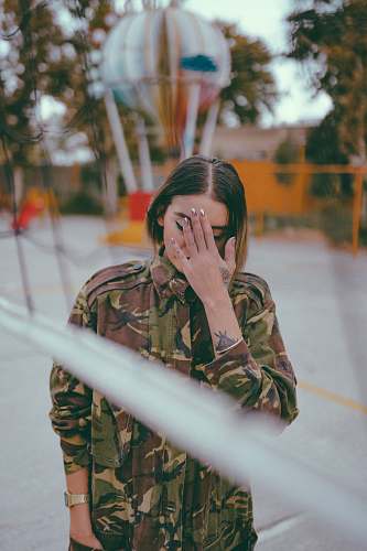 armored woman holding her forehead military uniform