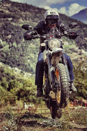 transportation close-up photography of man riding motorcycle during daytime vehicle