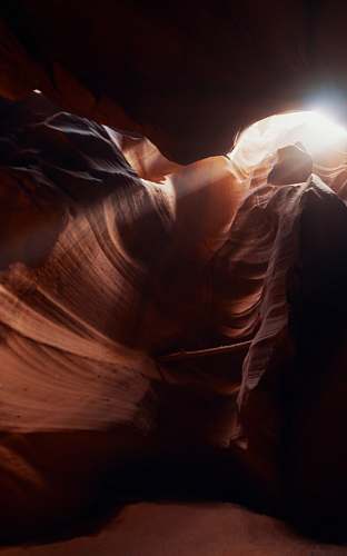 outdoors sun rays coming through cave view mountain