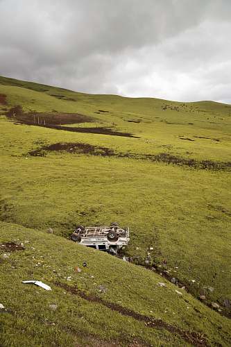outdoors white vehicle on green hill ground