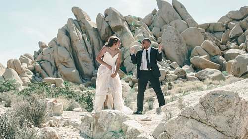 person newly couple standing on rocks outside human