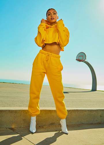 fashion woman in yellow tracksuit standing on basketball court side human