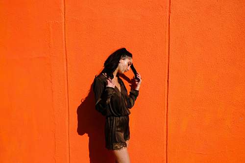person woman near orange wall human